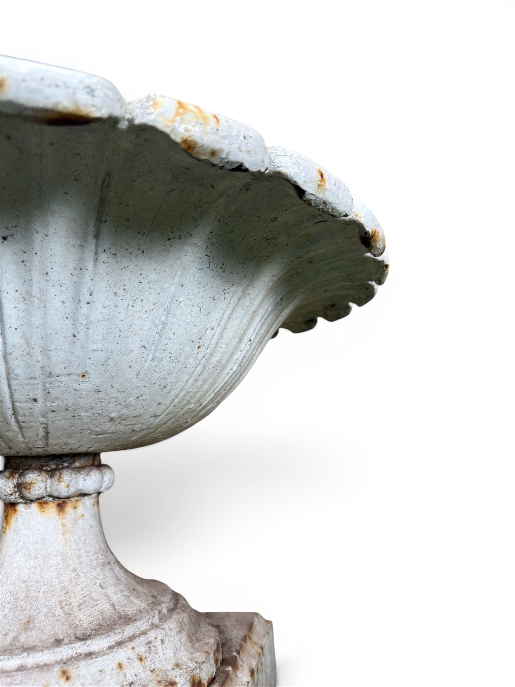 Coalbrookdale - pair of 19th century cast iron petal rim urns, squat form on square plinth, finished in distressed white paint, design registration number 133334, first registered 19 september 1860, number 19 in the Coalbrookdale Castings Catalogue (see illustration)