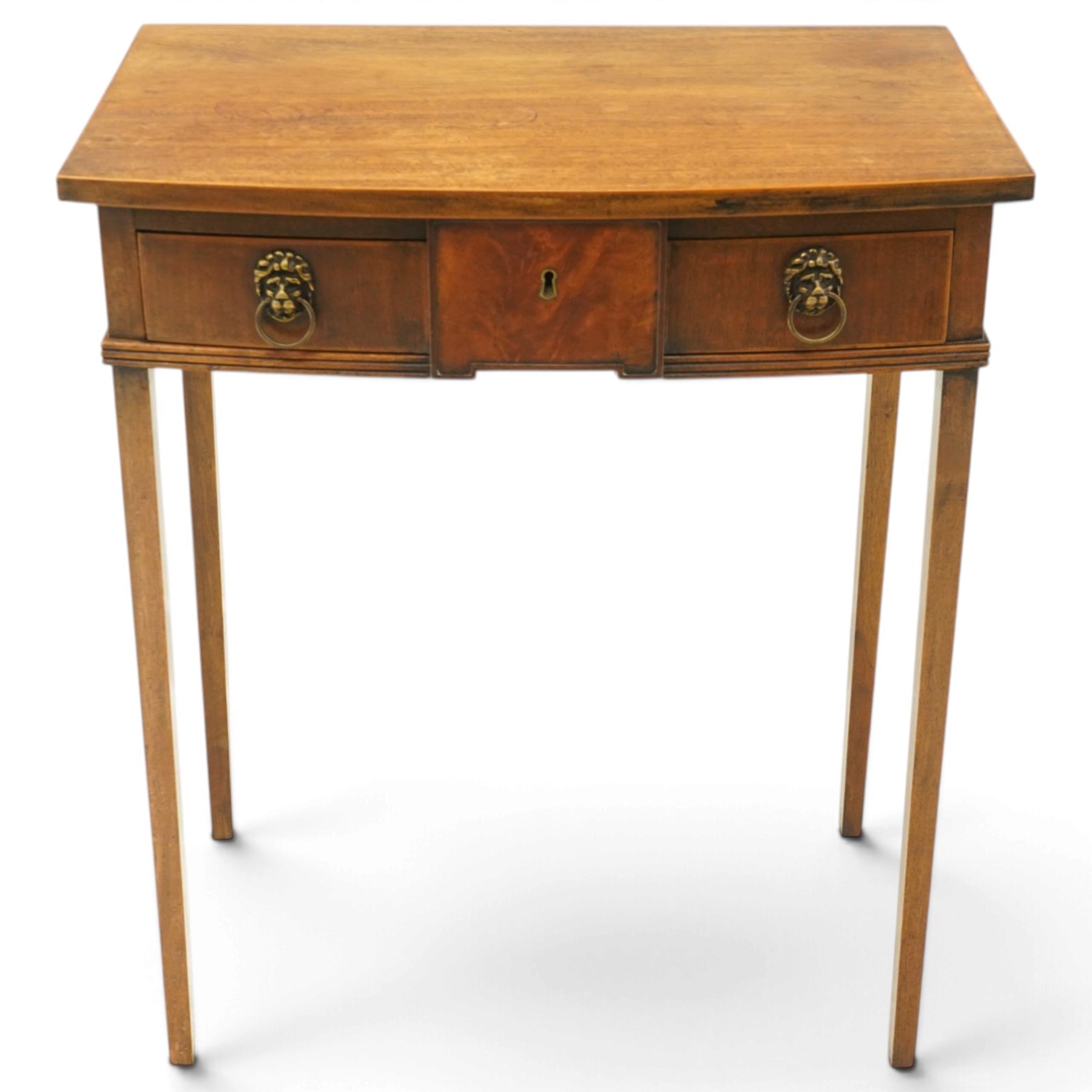George III mahogany bowfront side table, fitted with single frieze drawer with brass lion-mask handles and twin candle-rests to each side, lower reeded edge on square tapering supports