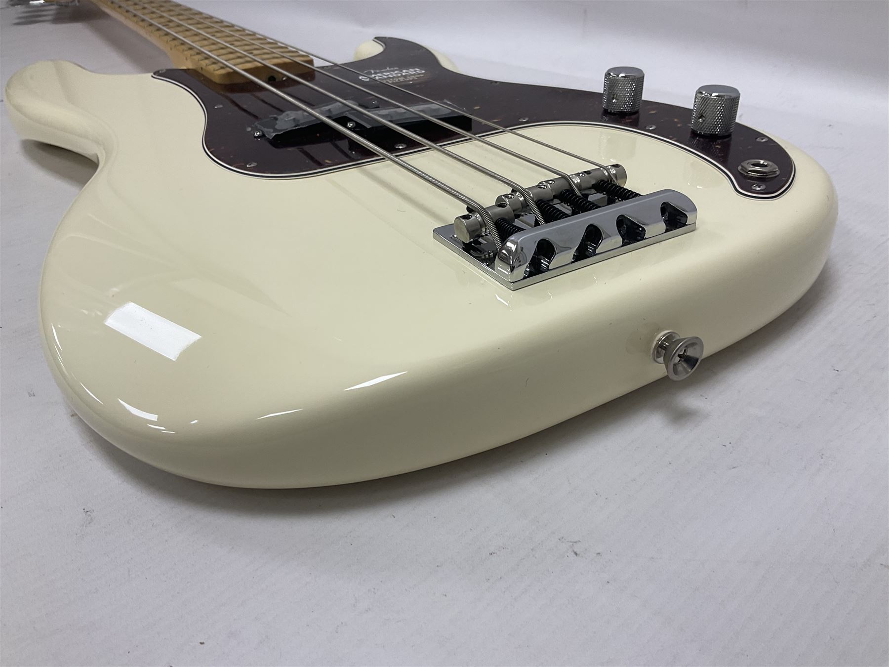 Fender Precision Bass guitar, in Olympic White finish with tortoiseshell effect scratchboard, serial no US15103092, in black Fender hard case with Fender strap and warranty card, guitar L116cm