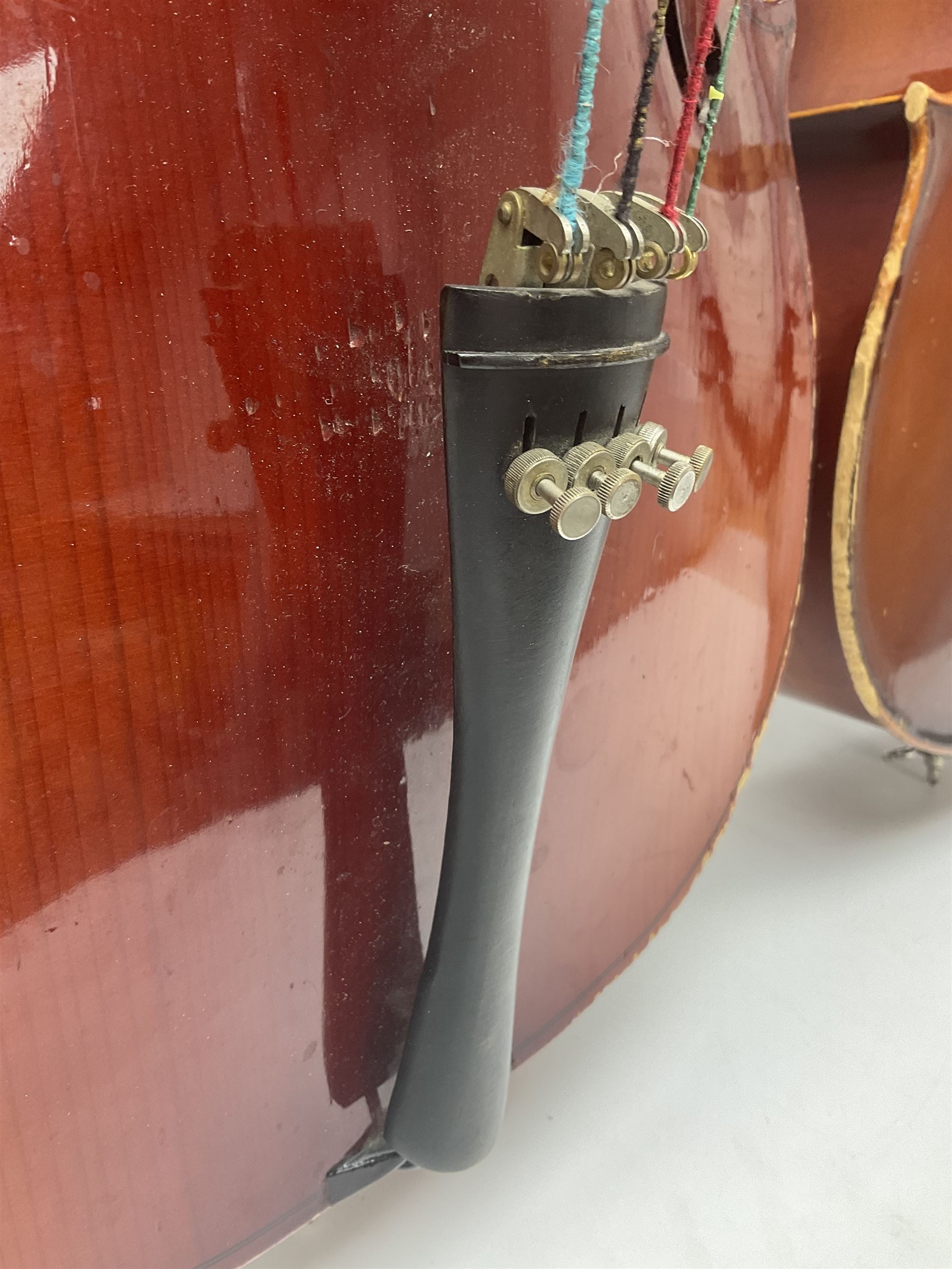 Two student half-size cellos - Boosey & Hawkes Artia with 65cm one-piece back and spruce top; bears maker's label; L104cm overall; and Romanian with 65.5cm two-piece maple back and ribs and spruce top; bears label; L108.5cm overall; each in soft carrying case with two bows (2)