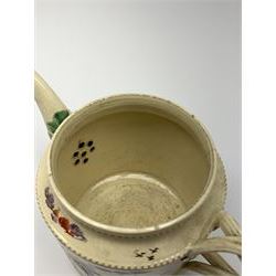 18th century creamware teapot, probably Leeds, with reeded entwined handle and floral finial to the cover, the body with hand painted polychrome decoration of figure to one side, and floral spray to the other, collectors paper label beneath inscribed Leeds Pottery, H11.5cm