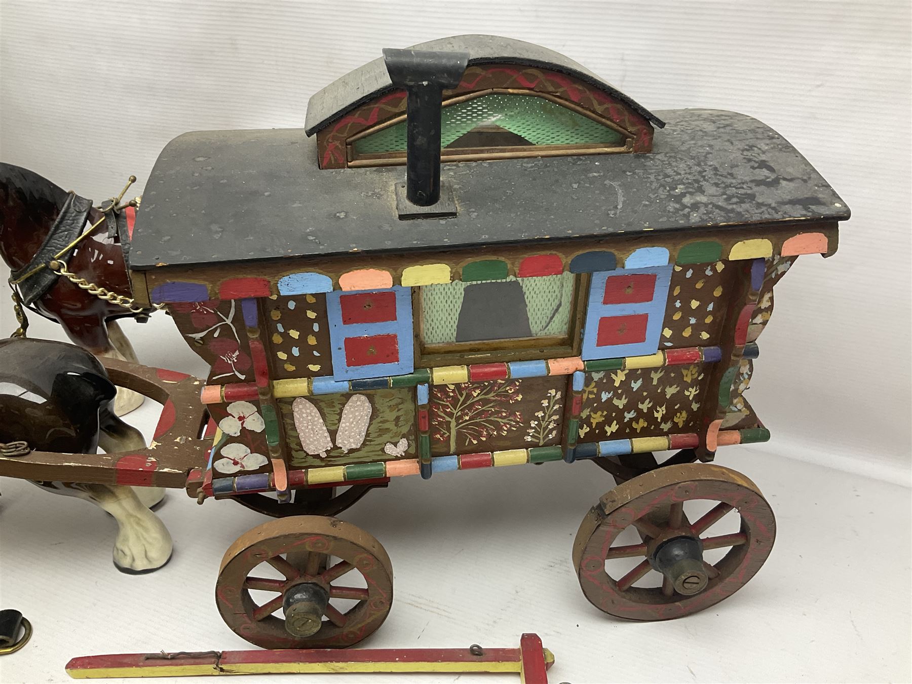 Two ceramic shire horse and gypsy caravans, together with horse brasses 
