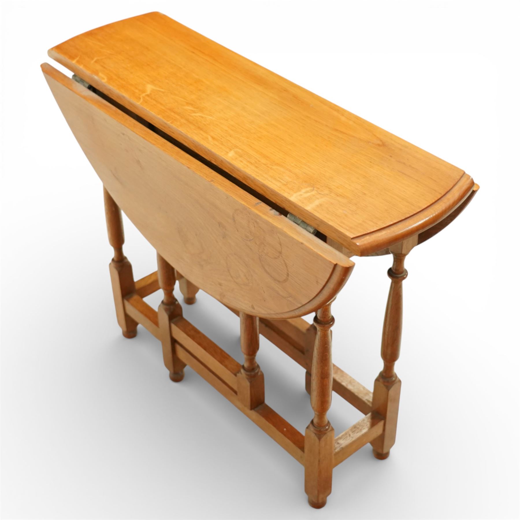 Late 20th century small oak gate leg side table, with circular drop-leaf top formed of three planks, raised on turned supports with gate legs and rectangular stretchers
