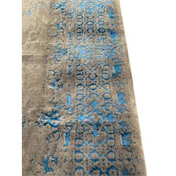 Large Persian grey stone and luminous blue ground carpet, decorated indistinctly with faded floral and scrolling patterns, central oval medallion decorated with scrolling foliage band