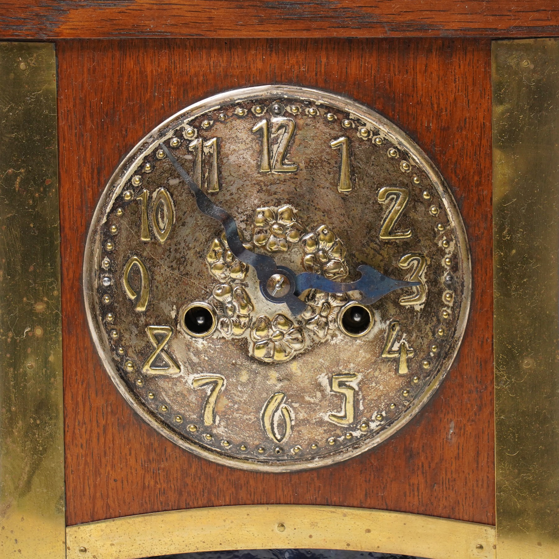 Arts and Crafts oak and brass mounted mantel clock, Hamburg-American Clock Company (HAC), for Liberty & Co, the eight day movement with bell strike, repousse dial with Arabic numerals H36.5cm

  