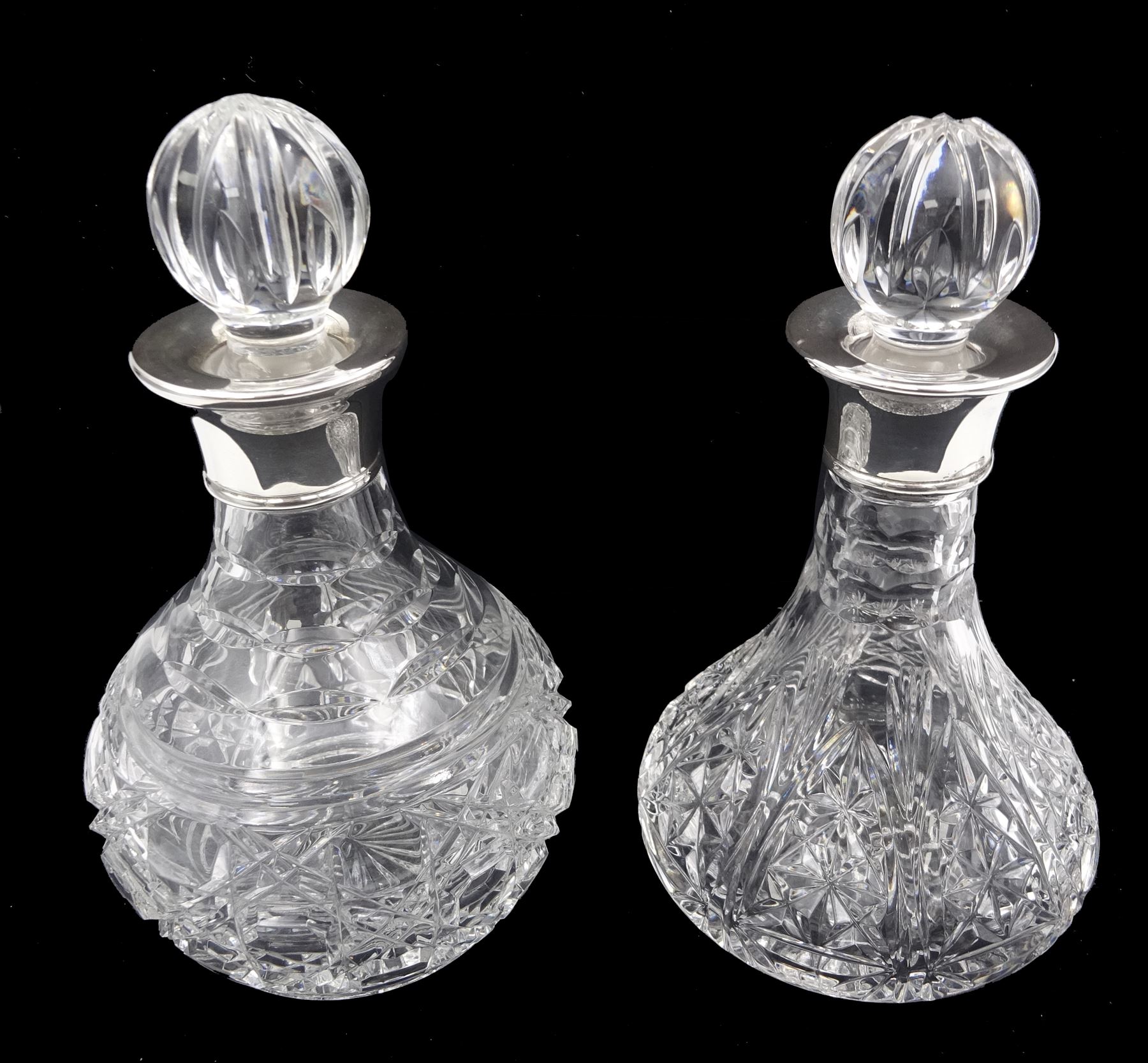 Two small modern silver mounted cut glass decanters, the first example of squat bulbous form, the body with navette, octagonal and hobnail cut decoration, with conforming stopper, the silver collar hallmarked Barker Ellis Silver Co, Sheffield 2005, H19cm, the second example, a ships decanter, with hobnail cut star decoration and conforming stopper, the silver collar hallmarked C J Vander Ltd, Sheffield 2005, H19cm, with boxes