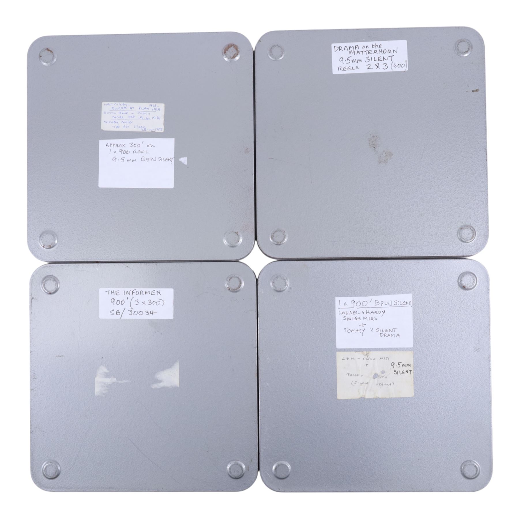 Fourteen 9.5mm cine film reels, mostly silent black and white, including two copies of The Informer (300ft on 900ft reel), Al Donahue, Laurel & Hardy 'Brats', George Formby 'No Limit', 'The Last Command', 'Emerald in the East', 'The Manx Man' Alfred Hitchcock 600ft on two reels, 'Captain Blood', Walt Disney Dwarf at Play 1928, Betty Boop and Pudgy 1936 and Mickey Mouse The Pet Store 300ft on one 900ft reel, Laurel & Hardy 'Swiss Miss' and 'Tommy' on one 900ft reel, 'White Hell of Pitz Palu' on two 900ft reels and 'Drama on the Matterhorn', all in square tin cases with hand written titles