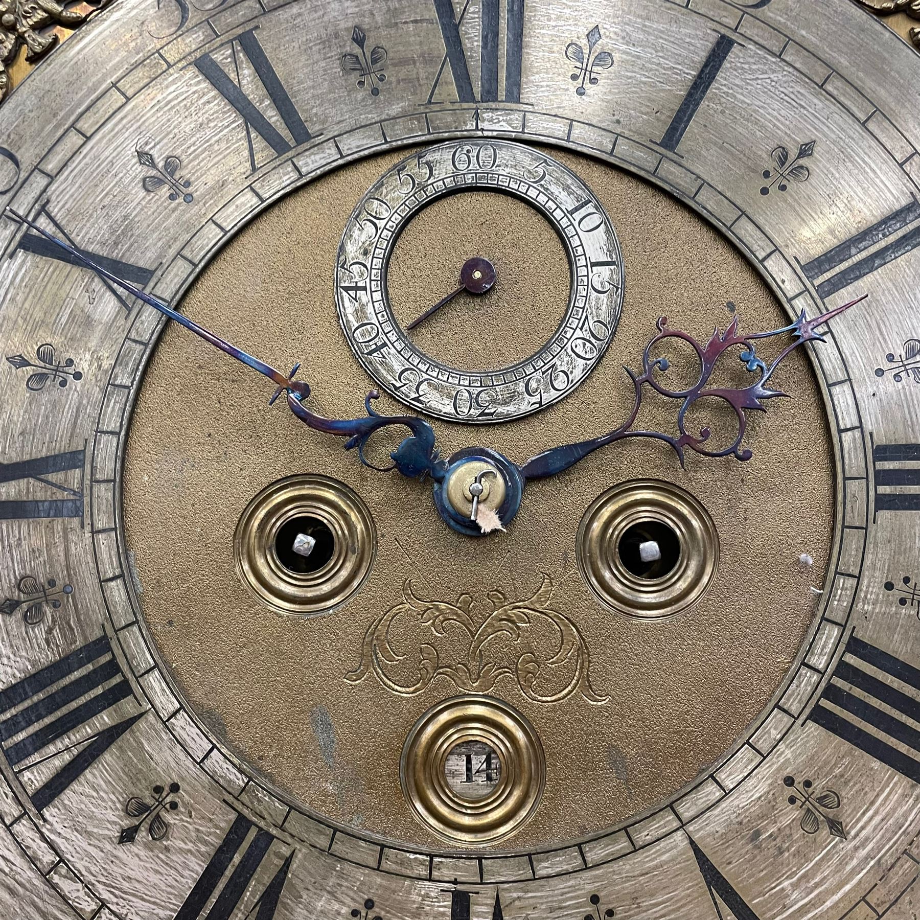 William & Mary floral marquetry 8-day longcase clock c 1700, later mid-18th century four pillar rack striking movement with a square brass dial and subsidiary seconds dial, ringed winding holes and calendar aperture to the matted dial centre, with London cherub head cast spandrels and (later) fretted steel hands, silvered Roman numeral chapter ring with stylised fleur di Lis half hour makers, narrow Arabic five-minutes, minute track and inner quarter hour track, signed Thomas Horlock, Hammersmith, 
case with box upstand to the domed floral marquetry decorated caddy with three brass flame finials, above a moulded cornice and fretwork frieze,  inlaid hood door with attached barley twist pillars to the front above an inlaid convex moulding, full length D moulded trunk door with a circular lenticle inlaid with floral and foliage panels inhabited with birds, on a conforming marquetry plinth with applied double skirting. Thomas Horlock is recorded as a Whitesmith & Clockmaker of Hammersmith, Middlesex.
A copy of Thomas Horlock's will dated the 15th June 1757 is held at The National  Archives Kew.