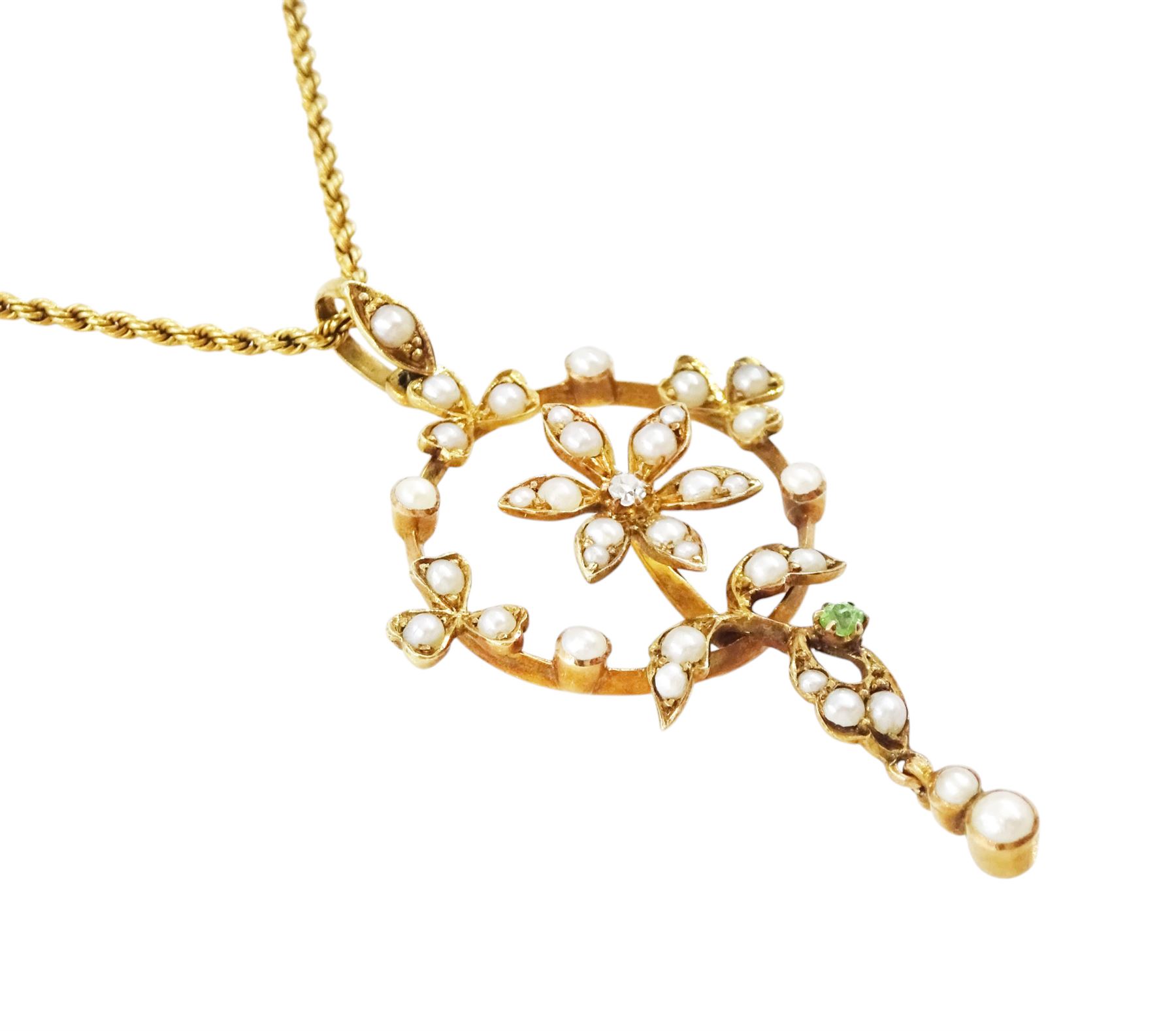 Early 20th century 15ct gold pearl, diamond and garnet pendant necklace, the flower wreath pendant, set with split pearls, a single old cut diamond  and green garnet, on a rope twist necklace, both stamped 15c