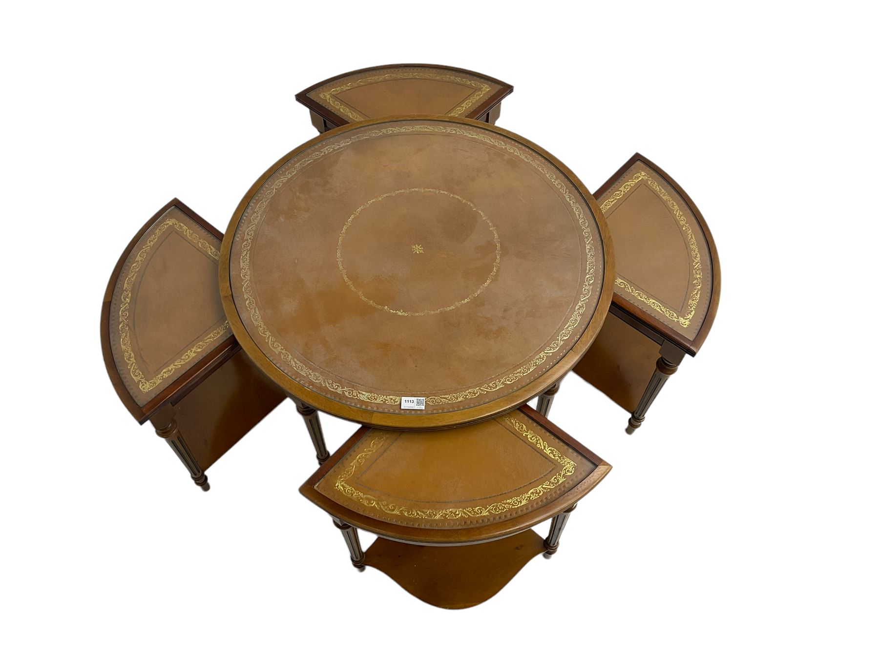 Yew wood circular coffee table with four nesting tables, inset leather and glass tops, on turned and fluted supports