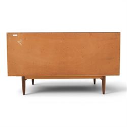 G-Plan - 'Brasilia' teak sideboard, with rectangular top above two concertina doors, above four drawers raised on cylindrical supports