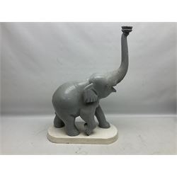 Composite figure of an elephant, painted grey, upon white base, L45cm H65cm