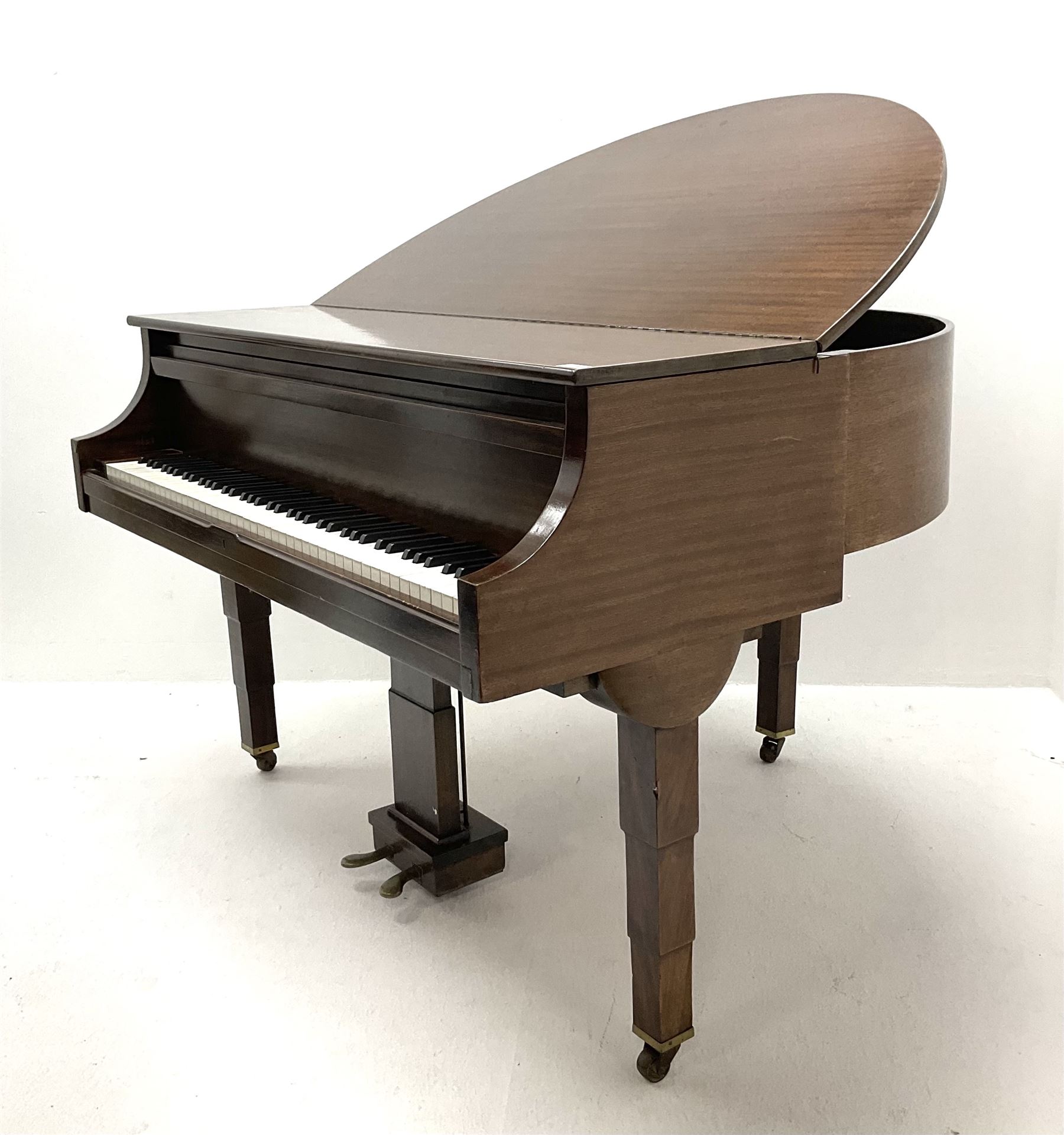 Early 20th century mahogany cased Strohmenger London baby grand piano, demi lune shape, over strung cast iron framed, raised on square tapered supports and castors 