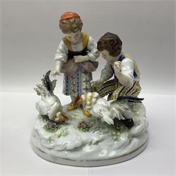 Two 19th century german figures, each modelled as children feeding birds, H19cm 