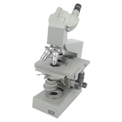 Three microscopes, including Griffin Student Vernier Microscope, Vickers Instruments binocular microscope with Leitz Wetzlar Periplan 10x lenses, and a Carl Zeiss Jena binocular microscope in a wooden Olympus Tokyo box