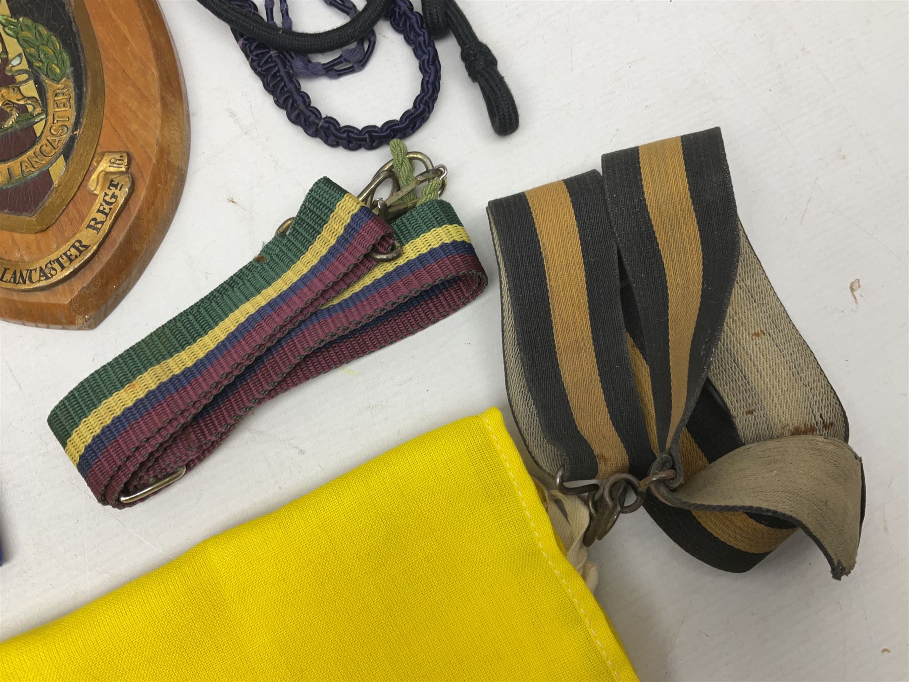 Miscellaneous militaria including two Royal Artillery and one Royal Horse Artillery stable belts; Northamptonshire Regiment trench art brass shell case lighter; unused Matchless Fire-Set; pocket knives and multi-tool; lanyards; oak shield with York & Lancaster crest etc