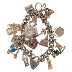 Silver charm bracelet, with seventeen charms including motorbike helmet, enamel toby jug, piano, etc