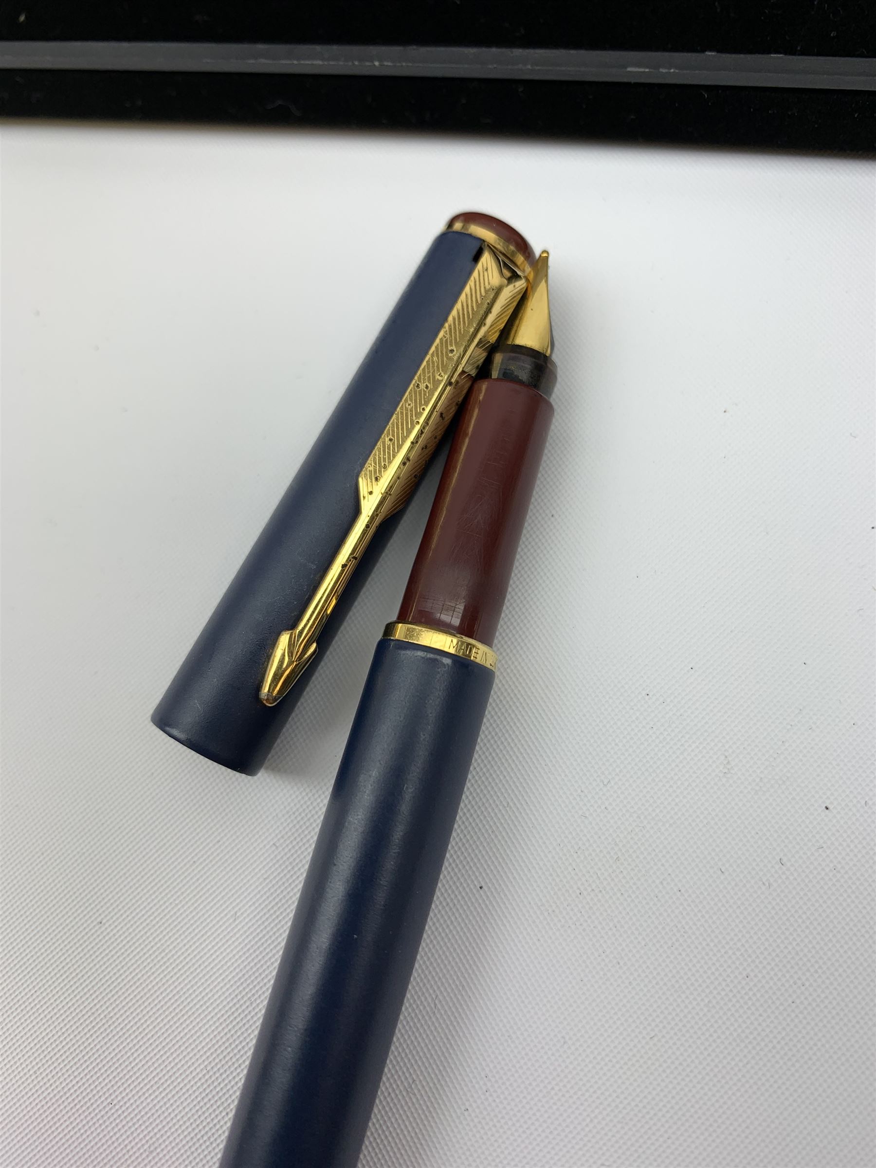 A group of pens, comprising Parker Duofold Centennial pearl and black ballpoint pen, Parker Frontier ballpoint pen, Ronson Penciliter, in original box, Parker Rialto fountain pen, and a further unmarked ballpoint. (5). 