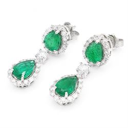 Pair of 18ct white gold emerald and diamond earrings, each stud set with two pear cut emeralds, surrounded by round brilliant cut and baguette cut diamonds, spaced by a single diamond, stamped, total emerald weight approx 4.15 carat, total diamond weight approx 1.50 carat