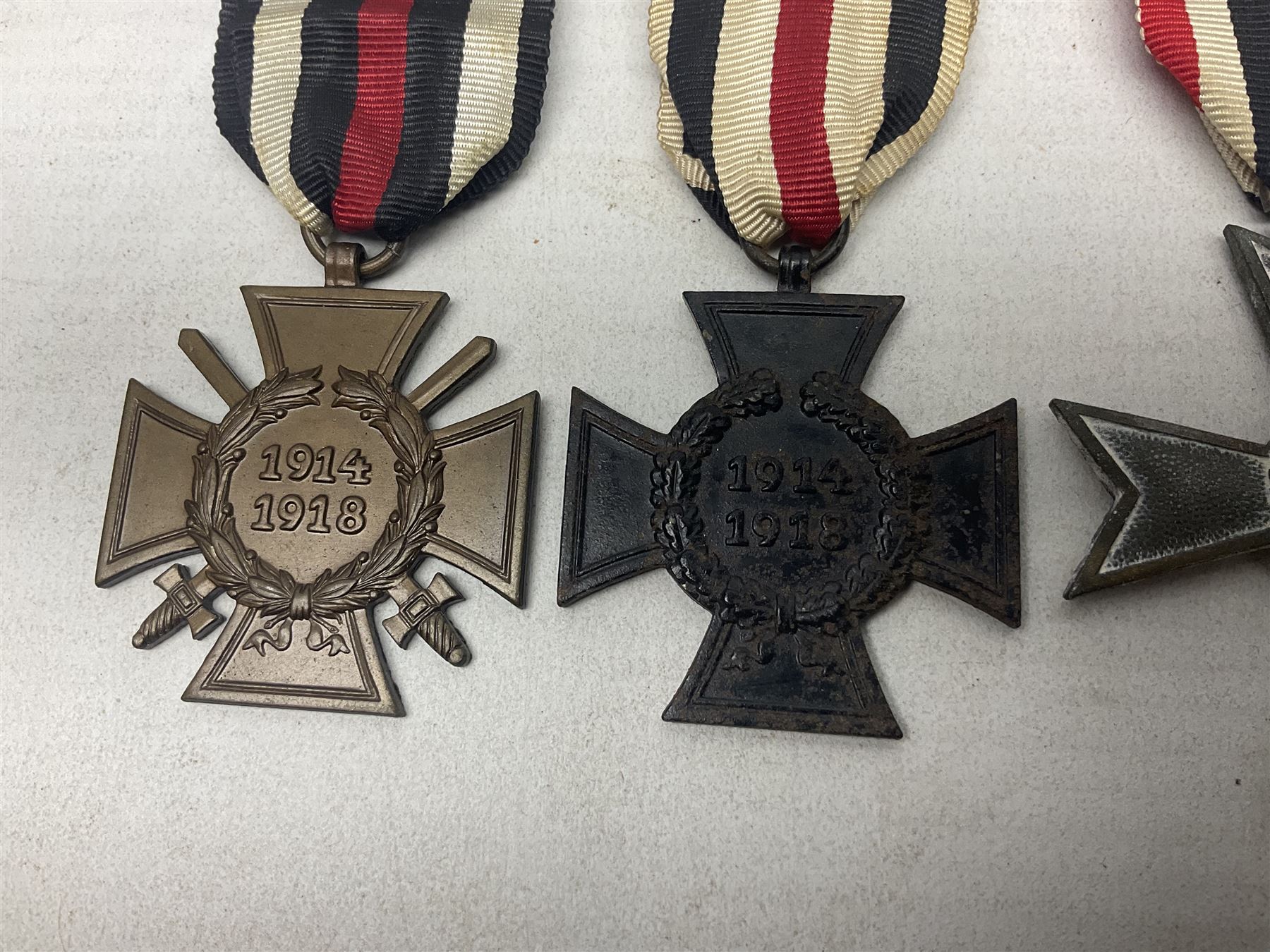 Two WW1 German medals - copy Cross of Honour with swords (combatants); Cross of Honour without swords (non-combatants); and two WW2 German medals - War Merit Medal; and War Merit Cross; all with ribbons (4)