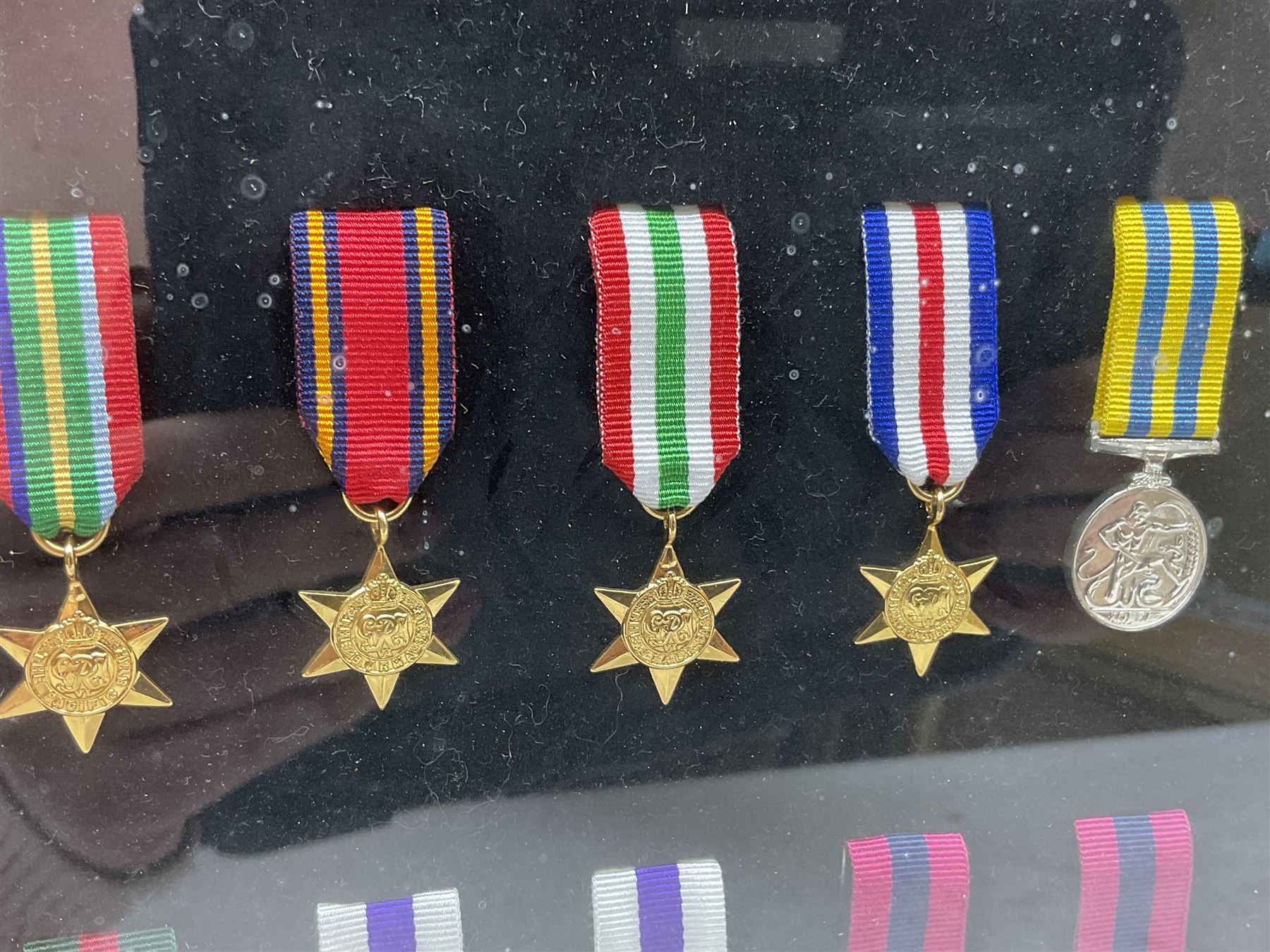 Limited edition large framed display board with sixty half-size copies of British Gallantry and Campaign Medals produced by Danbury Mint; all with ribbons and associated booklet