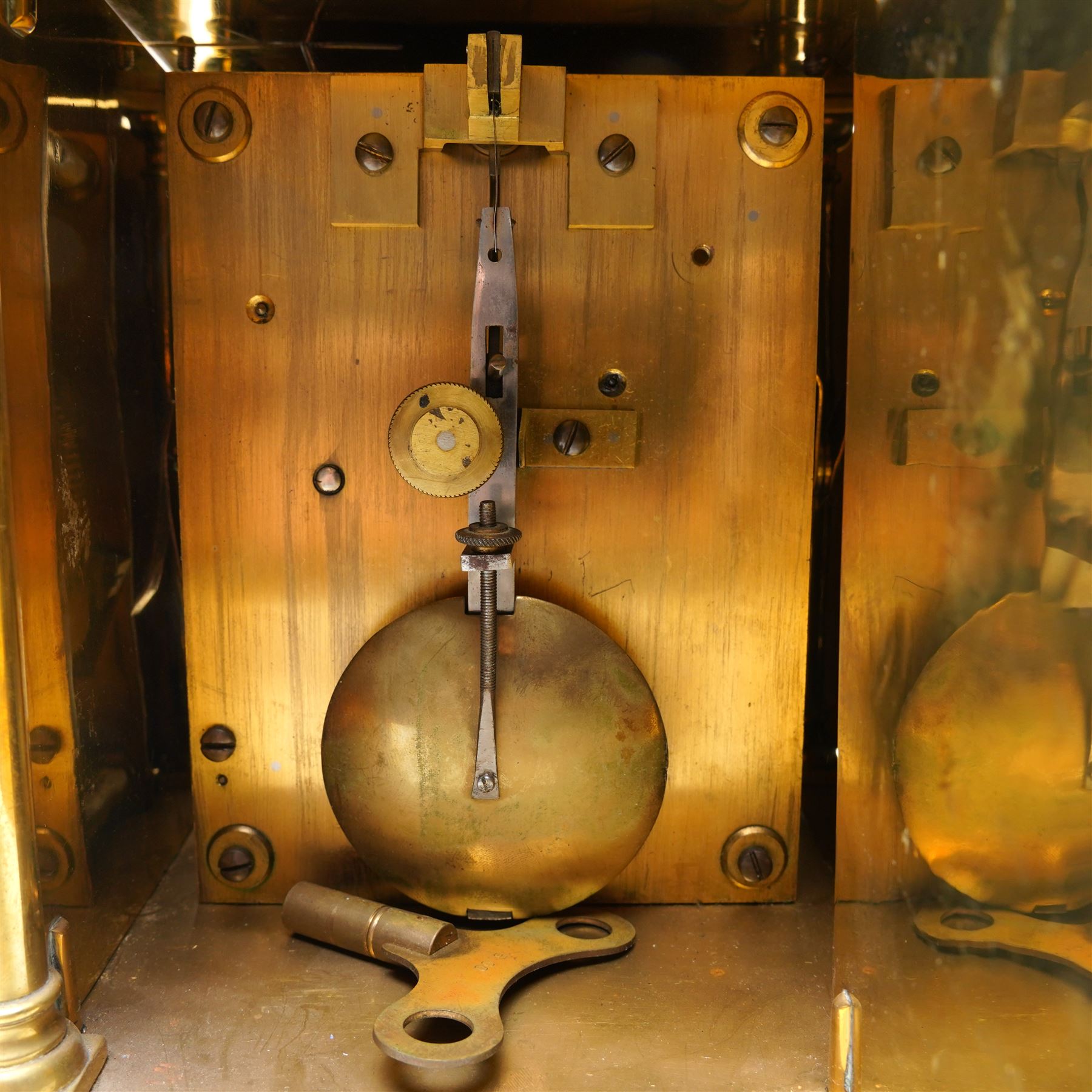 English-17th-century style replica 8-day lantern clock with a suspended bell and turned finials, with three ornate frets to the front and sides and opening side and rear doors, with an engraved dial centre and formerly silvered chapter with engraved Roman numerals, inner quarter hour track and period steel hands, dial engraved 