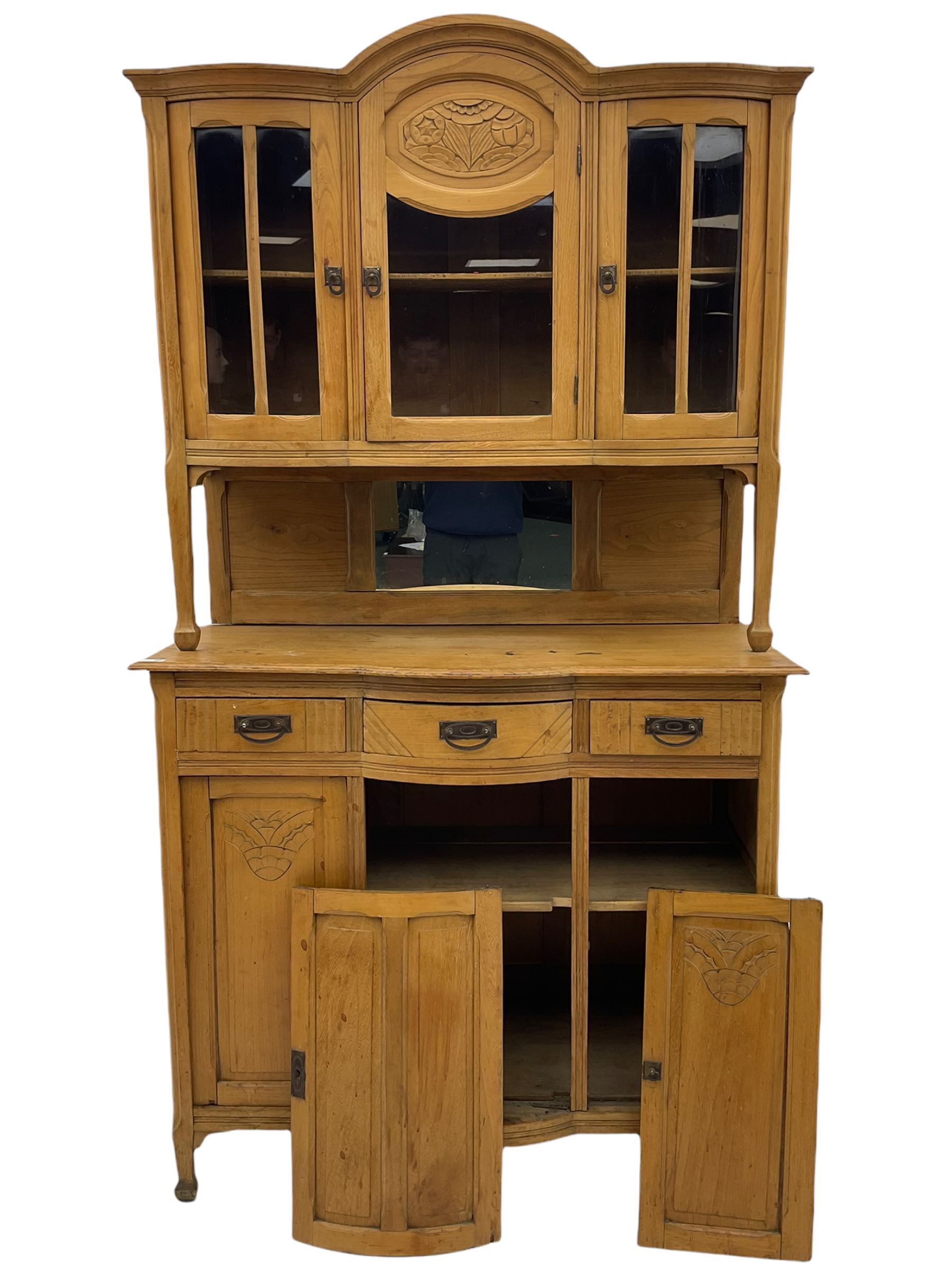 19th century elm dresser, the raised arched top enclosed by three glazed doors, the central door
