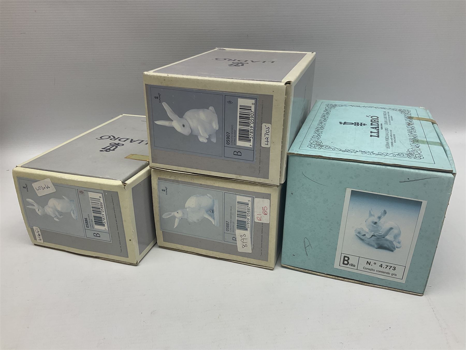 Four Lladro rabbit figures, comprising, Hippity Hop no 5886, Sitting Bunny no 5907, Washing up no 5887, and Rabbit Eating no 4773, largest example 14cm  