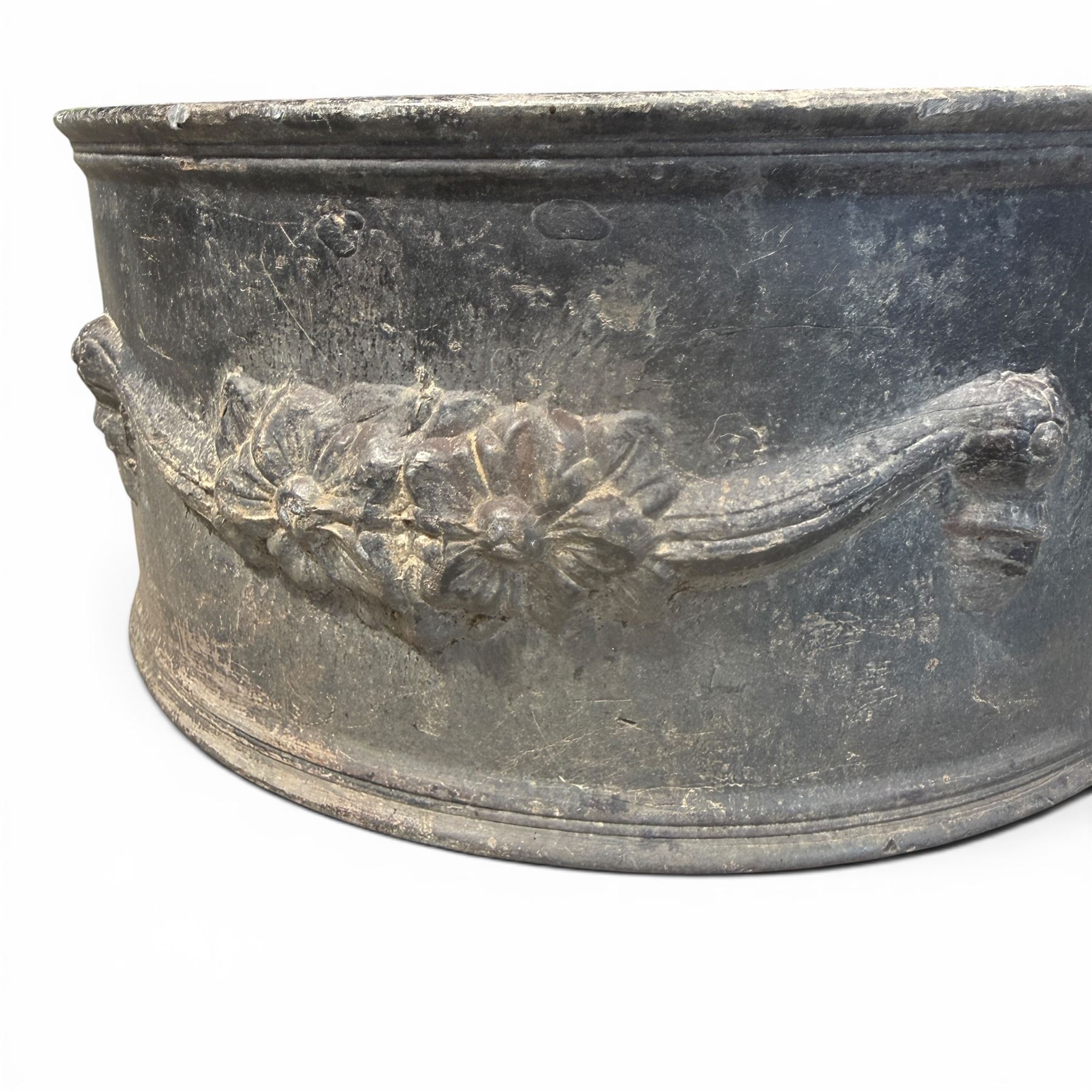 Pair of 19th century decorative lead planters of demi-lune form, decorated with raised relief floral swag decoration