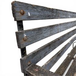 19th century wrought iron strapwork and slatted wood garden bench, the arm terminals and end supports of scrolling form