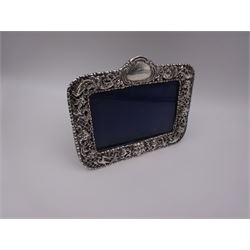 Victorian silver mounted photograph frame, of rectangular form, with bead and dart rim, pierced and embossed green man mask, lattice, bird and foliate decoration and engraved cartouche to top centre, with easel style support verso, hallmarked William Comyns & Sons, London 1898