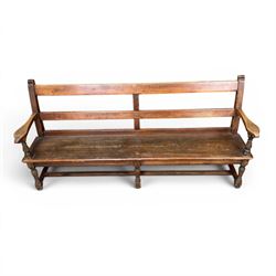 Early 20th century pine and oak bench seat, stained pine rail back frame with shaped oak arms