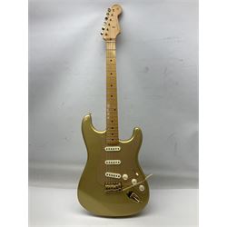 Fender Stratocaster 50th Anniversary 2004 metallic gold electric guitar; serial no.MZ4116369; L98cm; in Spider fitted case with owners manual and other paperwork, strap and belt buckle etc