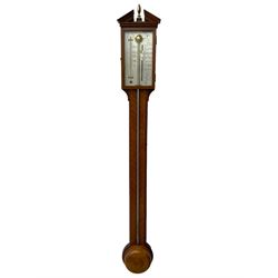 20th century - mercury cistern barometer in an 18th century style mahogany case with contrasting inlay and a broken pediment, round base with a turned cistern cover, fully exposed glass tube and silvered register within a glazed door, with a Fahrenheit spirit thermometer, engraved weather predictions and sliding vernier. Mercury clean and present.
