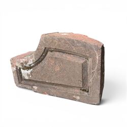 Pair of 19th century hewn and carved stone wall ends, the facias carved as shaped faux fielded panels