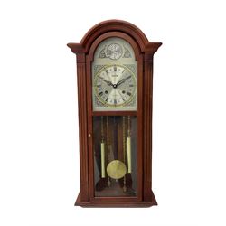 A contemporary Acctim (Anglo continental clock company) thirty-one day striking wall clock in a mahogany effect case with a fully glazed door displaying the pendulum and two dummy wights with chains, with a polished brass dial, Roman numerals, minute track and pierced steel hands, dial plate decorated with spandrels and Tempus Fugit inscribed on the dial brake-arch.
With key and pendulum.

