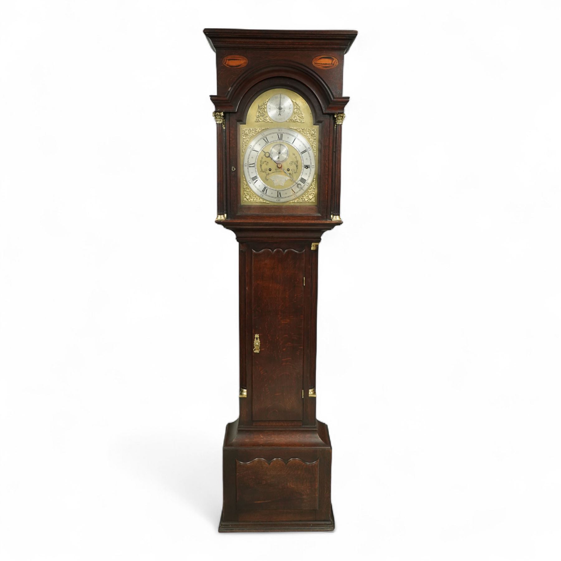 Lister of Halifax -  Oak cased musical longcase clock c1790, 8-day movement sounding the quarters and hours on bells or gong rods, case with a flat pediment and oval  conch inlay beneath, break arch hood door with reeded pilasters and brass Corinthian capitals, trunk with conforming quarter recessed pillars and a long wavy topped door, plinth with a raised panel and applied moulding the the base, break arch brass dial with cast spandrels and engraved dial centre, with a silvered chapter, seconds dial and cartouche with makers name, gongs or bells selector to the arch, chapter with Roman numerals, five minute Arabic's, minute track and steel moon hands, dial pinned directly to a three train weight driven movement with a nest of eight bells and eight gong rods, sounding the hours on either bells or gong rods, with a rack strike and recoil anchor escapement. With pendulum and weights.
The Lister family were a prodigious family of prolific clockmakers working in Halifax and the West Riding area of Yorkshire during the 18th and 19th century, well-known and noted for producing a number of chiming and musical longcase clocks.