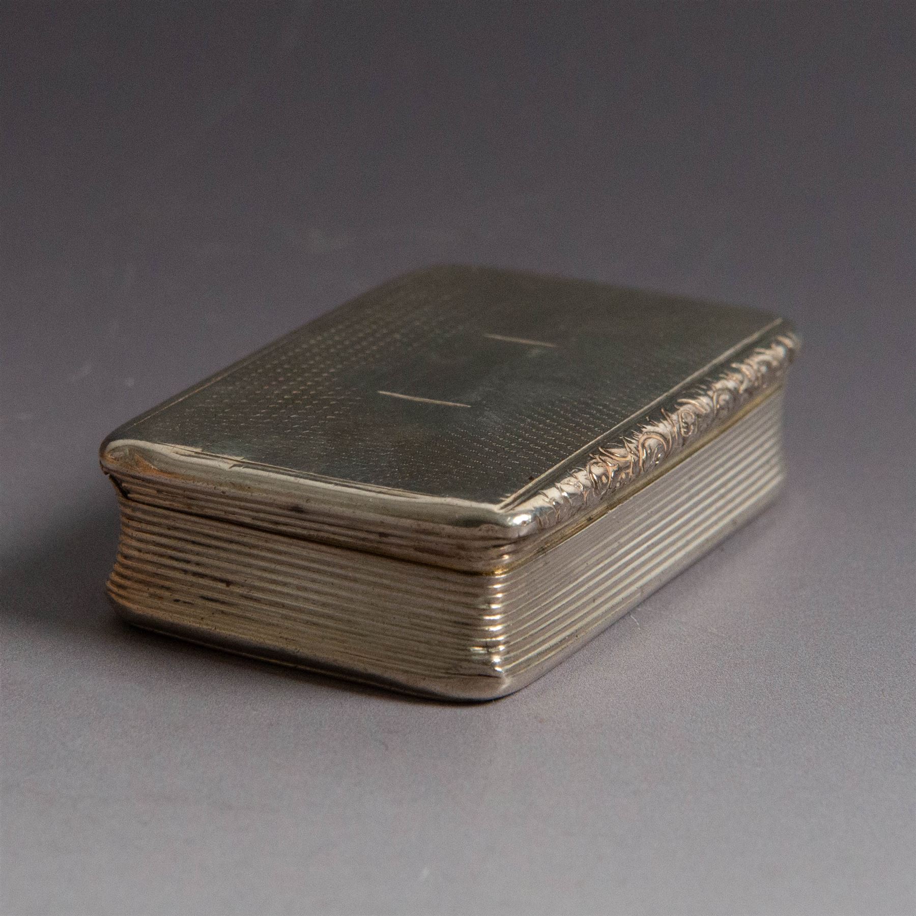 William IV silver snuff box, of rectangular form with rounded corners and embossed lip, the hinged cover with engine turned decoration and vacant cartouche, hallmarked Joseph Willmore, Birmingham 1830, H2cm, W7cm