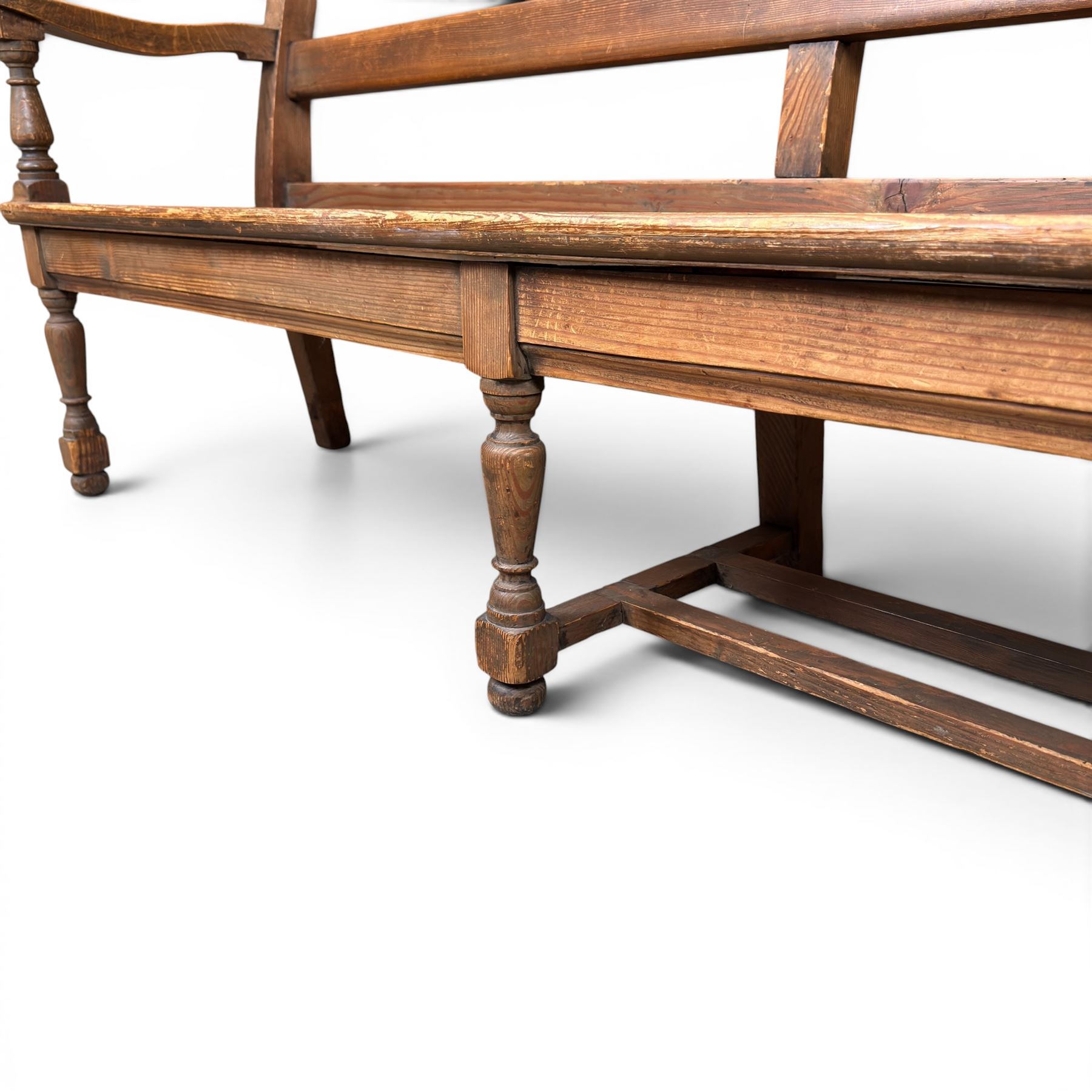 Early 20th century pine and oak bench seat, stained pine rail back frame with shaped oak arms