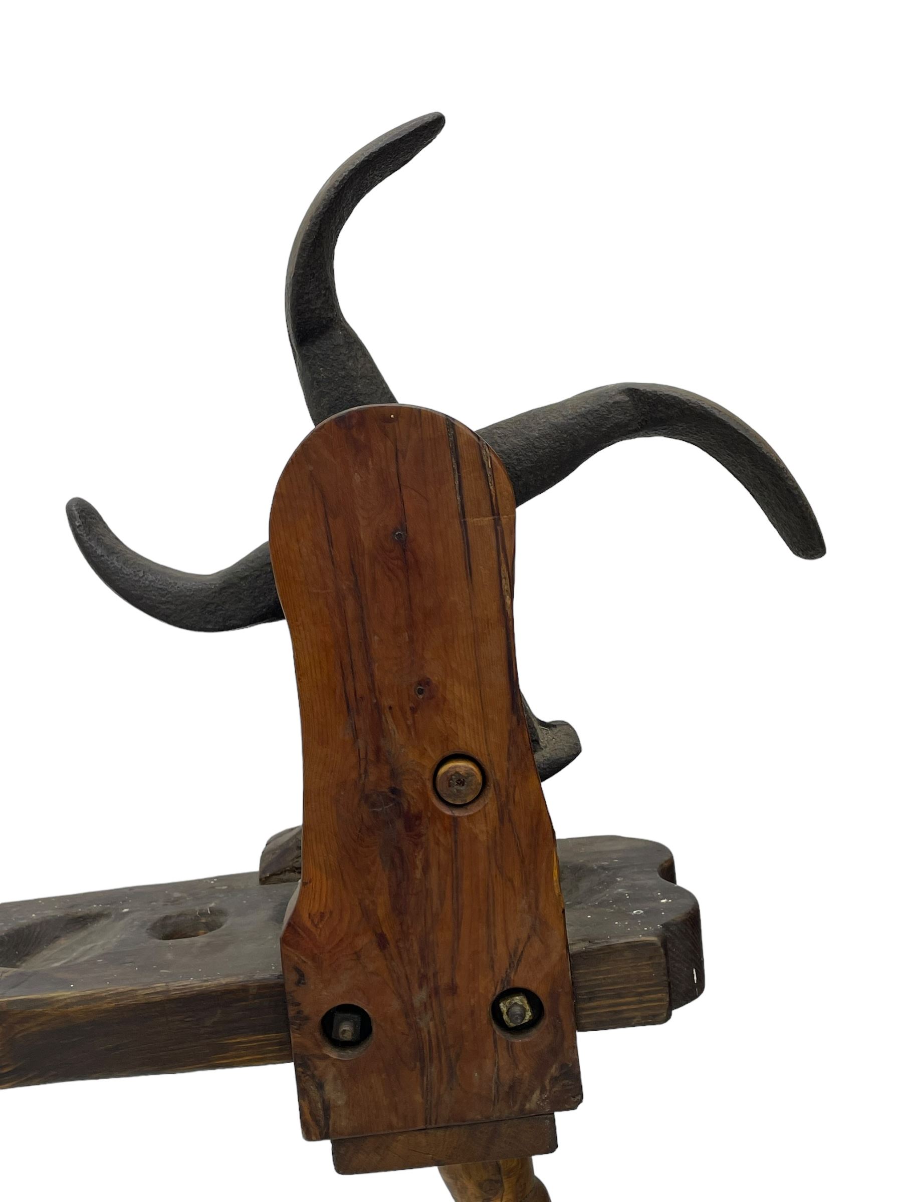 Early 19th century cobbler's work bench, in various woods, revolving cast iron last on yew wood supports, pine seat with inset maker's plaque inscribed 'No 7 Josh Blacker Harehills Leeds', on turned elm front supports and turned beech rear supports 