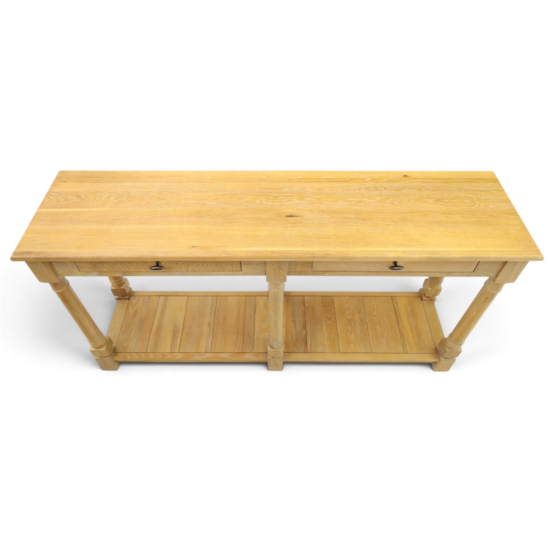 Neptune - 'Edinburgh' limed oak console table, with two
soft close drawers raised on ring-turned column supports,
with a pot shelf raised on square feet