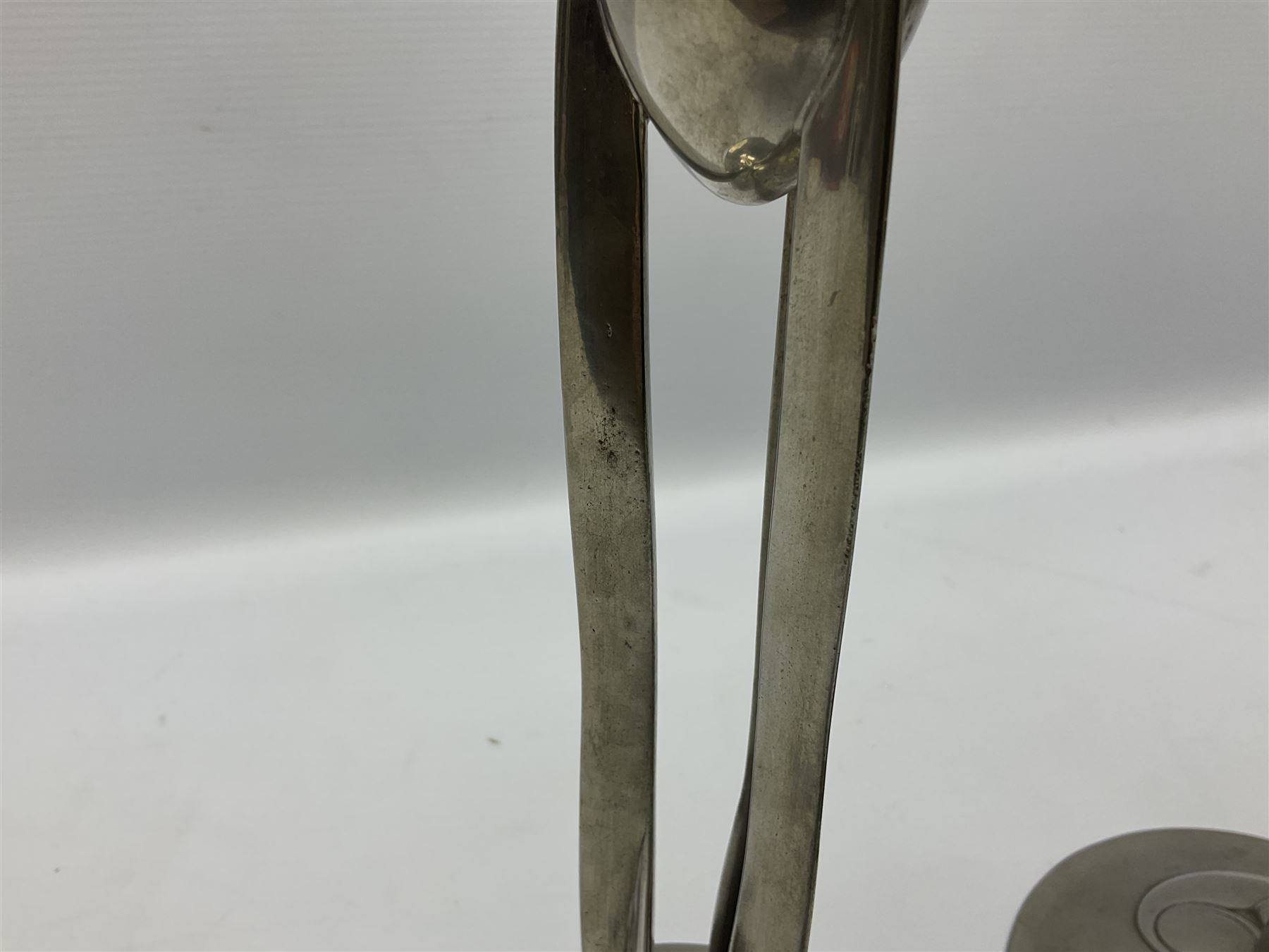 Archibald Knox (1864-1933) for Liberty & Co, pair of Tudric pewter candlesticks, the bud shaped sockets raised upon three angular fin supports and a slightly domed circular base with cast stylised foliate decoration, each stamped beneath Tudric 0223, H30cm