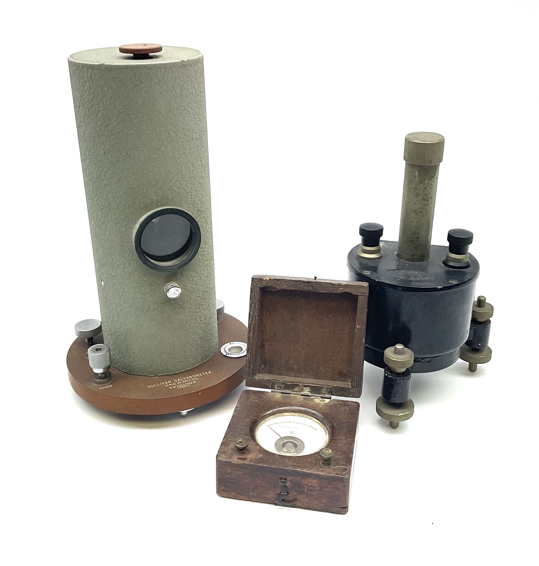 Two mirror galvanometers - one marked Sullivan Galvanometer serial no.1483/1950 of green crackled cylindrical form on circular base H24cm; the other by W.G. Pye & Co. Cambridge marked G107-131 on tripod base; together with an ammeter in wooden case (3)
