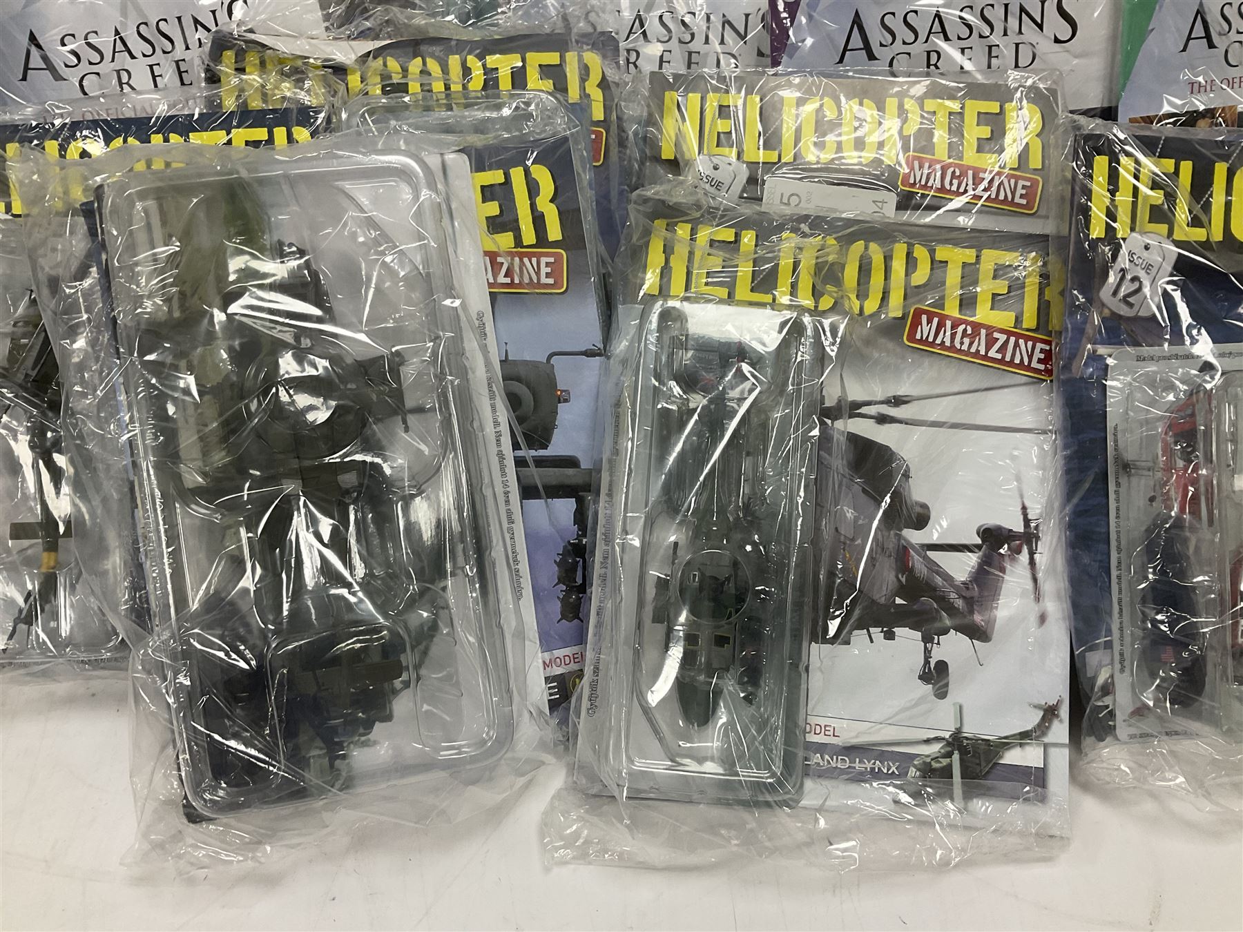 Fifteen Amer Czechoslovakia periodical issued metal models of helicopters each in unopened original packaging with copy of 'Helicopter Magazine'; together with seven unopened Hachette 'Assassin's Creed' periodical figures with magazines (22)
