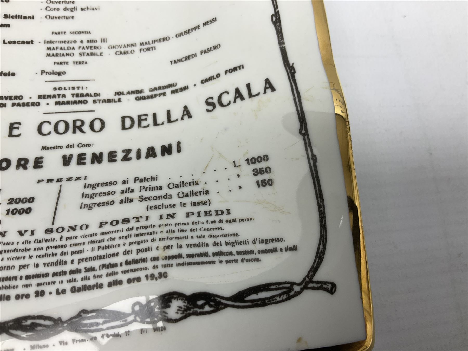 Fornasetti rectangular 'Toscanni's Concert' poster ashtray decorated with black and white text with a gilt border edge, with printed mark beneath, H22cm 