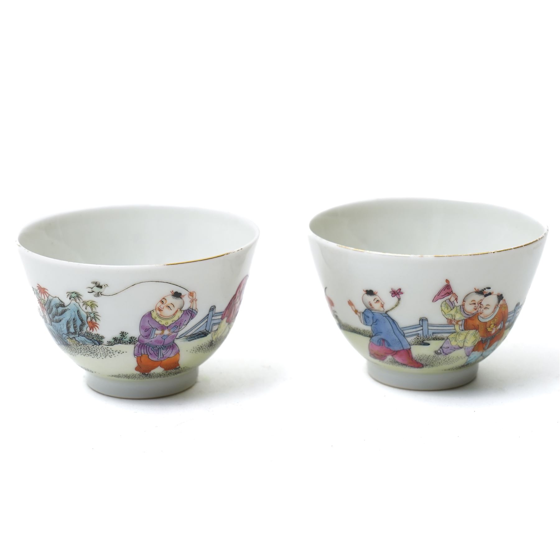 Pair of Yongzheng style tea bowls, decorated with boys playing with birds and butterflies, apocryphal six character mark within blue square to base, H4.5cm