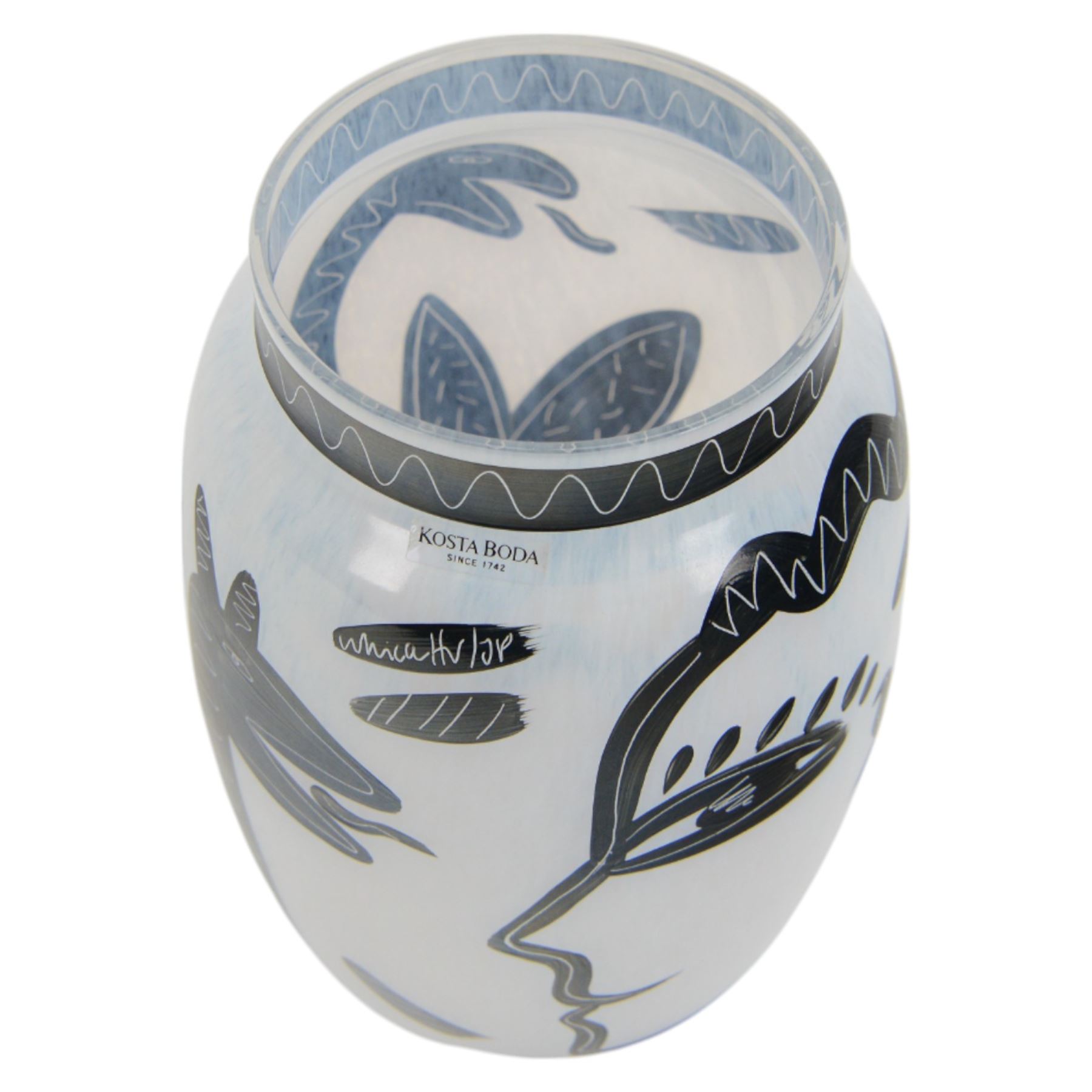 Kosta Boda Open Minds glass footed bowl, the clear glass bowl painted with female facial features, together with a Kosta Boda Caramba vase, of baluster form painted in black with a head in profile and a two headed beast on a white ground, both designed by Ulrica Hydman-Vallien, tallest H19.5cm