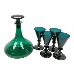 19th century green glass ships decanter with flat topped stopper, H21.5cm, together with a set of four 19th century green glass wine glasses, the funnel bowls upon bladed knopped stems and circular feet, H13cm