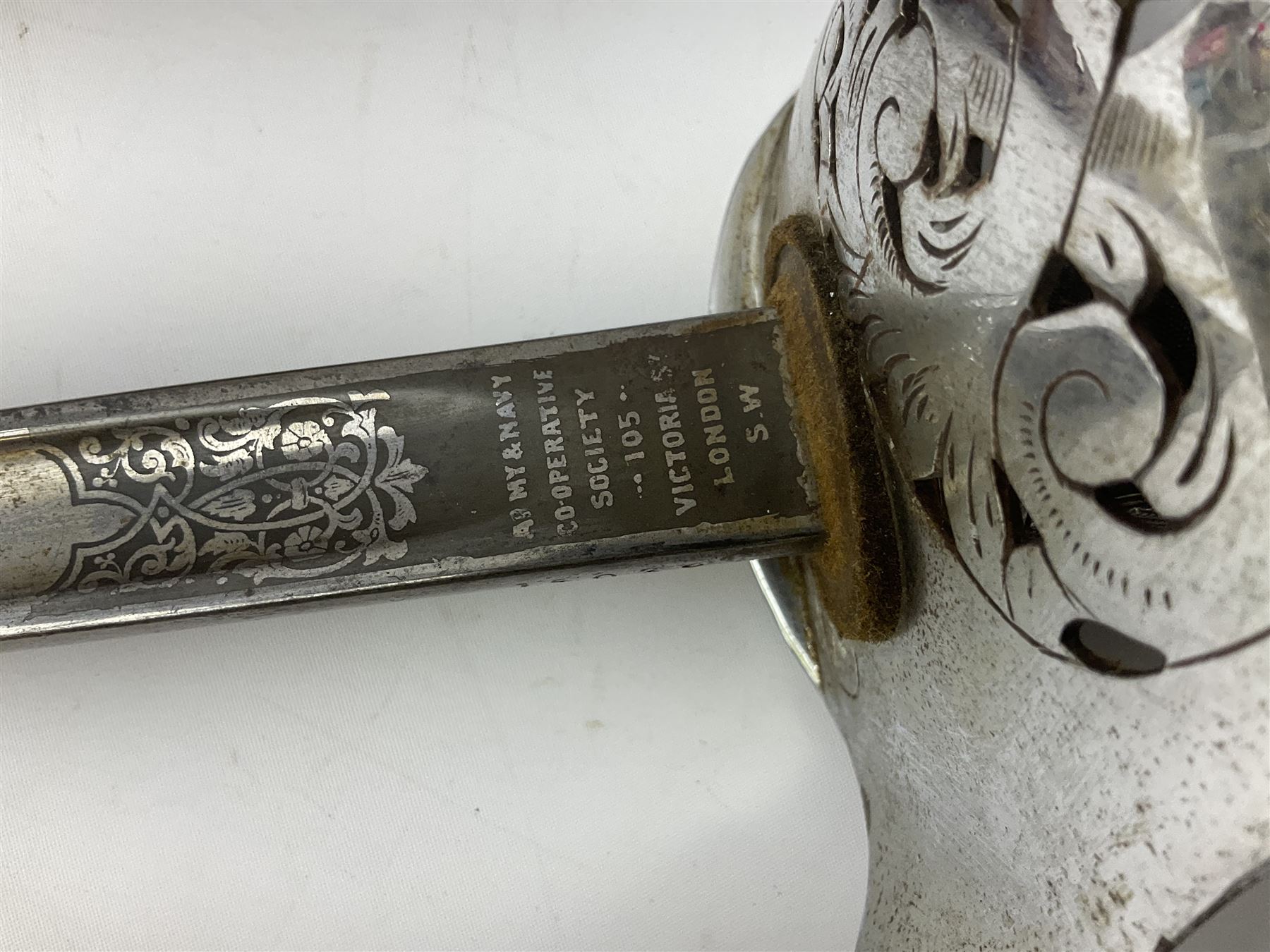 British George V 1897 Pattern Infantry Officers Sword, the 82.5cm fullered steel blade etched and polished with crowned royal arms, GRV cyphers and scrolling foliage, marked Army & Navy Co-operative Society 105 Victoria St London SW to the ricasso,  plated pierced basket hilt with wire bound fish skin grip and leather knot, No.15032; in leather covered scabbard