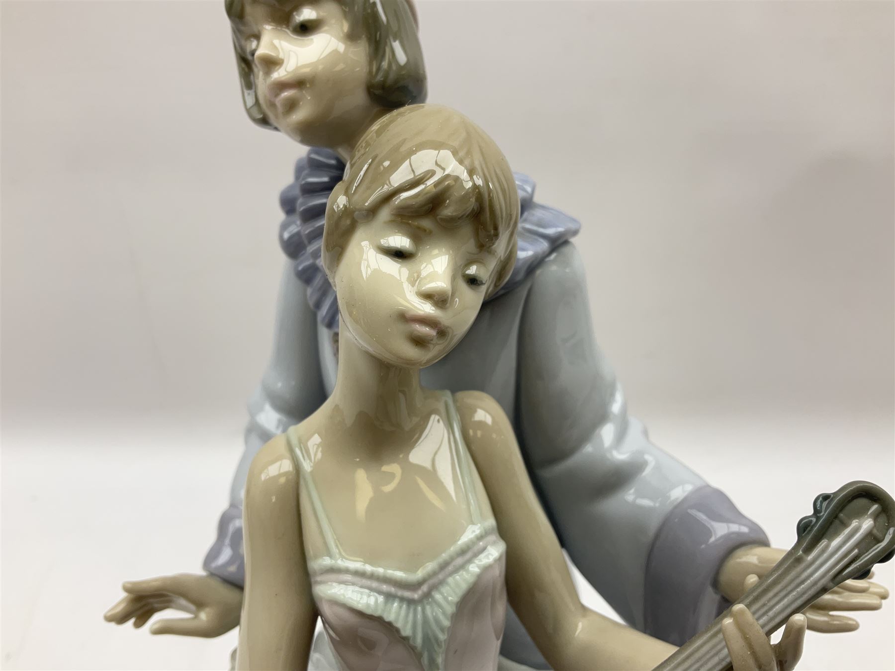 Lladro figure, Minstrel's Love, modelled as a couple entertaining, the lady in ballerina costume playing the lute and the gent stood behind her in jester type dress, sculpted by Rafael Lozano, with original box, no 5821, year issued 1991, year retired 1993, H31cm